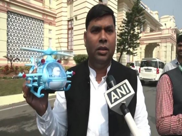 Rashtriya Janata Dal (RJD) leader Mukesh Raushan with toy helicopter (Photo/ANI)