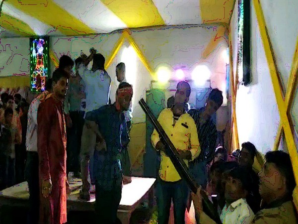 A man shooting in the air at a wedding ceremony in Arrah, Bihar.