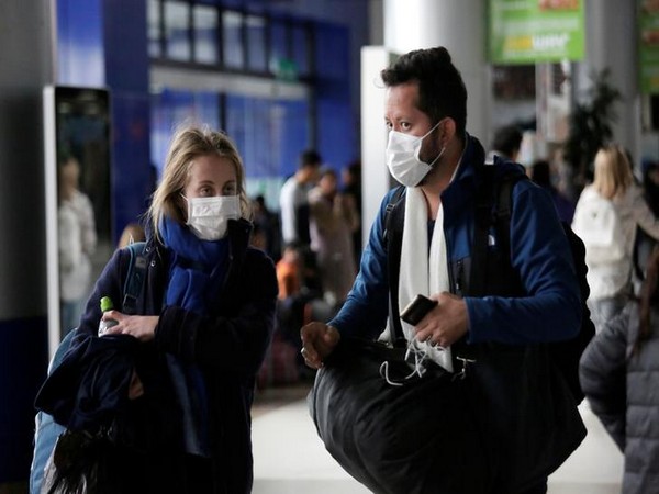 Passengers wear masks, during measures to curb to a coronavirus, at El Alto International Airport in the outskirts of La Paz