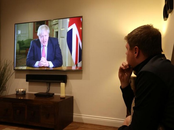 A man watches British Prime Minister Boris Johnson's PC on coronavirus in Newcastle-under-Lyme, Britain.