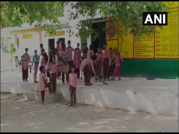 Student of a govt primary school in Bulandshahr seen sweeping the floor of the school.