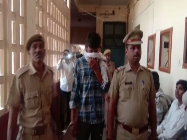 Police personnel with the accused Jaideep in Bulandshahr, Uttar Pradesh on Saturday. Photo/ANI
