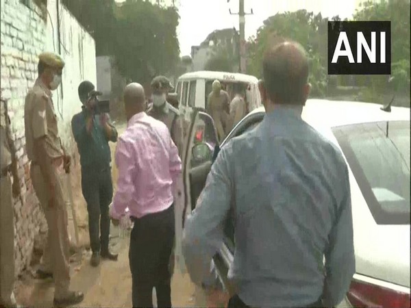 CBI officials along with police in Bulgarhi village of Hathras on Thursday. (Photo/ANI)