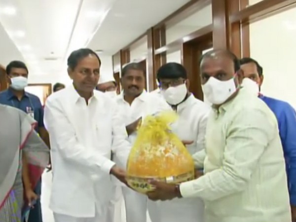 CM KCR being presented the famous Balapur Ganesh Laddu by committee members. Photo/ANI