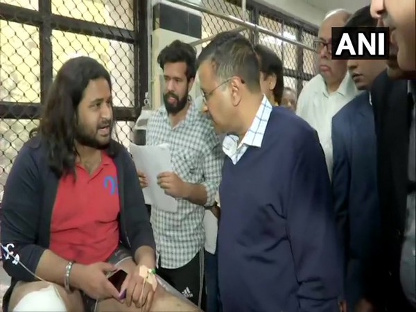 Delhi Chief Minister Arvind Kejriwal speaking to one of the victims in GTB hospital in New Delhi on Tuesday. Photo/ANI