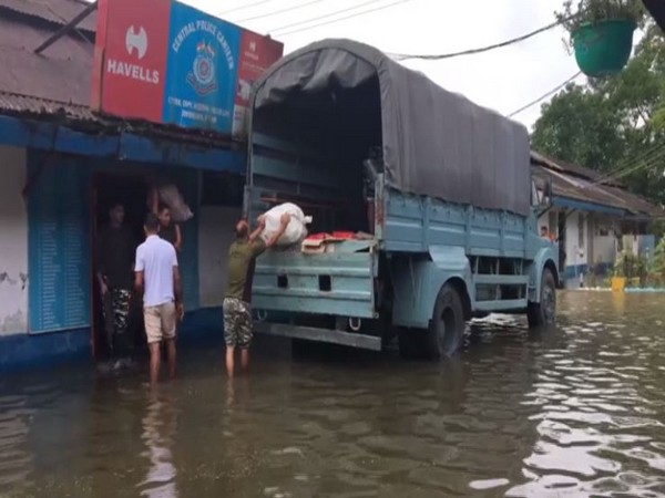 Soldiers moving out of the inundated CRPF camp of 171 Battalion