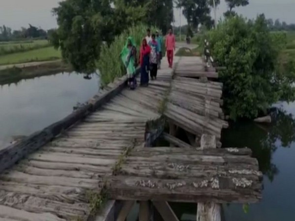 Locals of Majha Kalan and adjacent villages of Basti Division struggle to cross the river via broken bridge. (Photo/ANI)