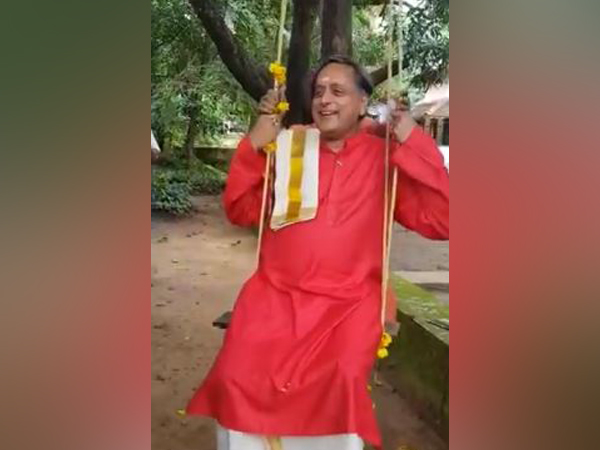 Congress leader Shashi Tharoor playing on the swing