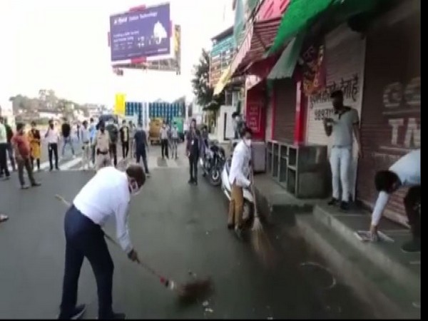 People sweeping roads in Indore (Photo/ANI)