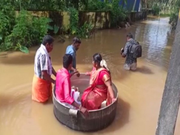 A bride and groom reached the temple in a cooking vessel for their marriage in Kerala's Alappuzha on Monday. (Photo/ANI)