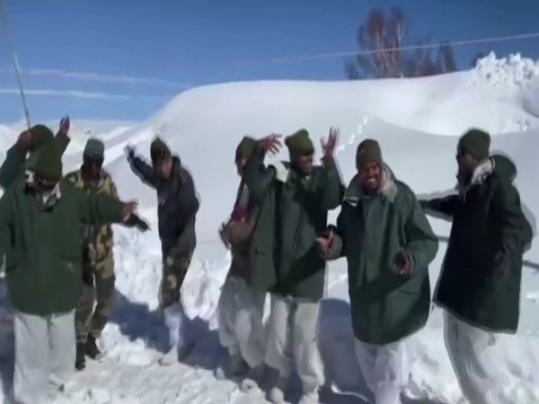 BSF jawans dancing in the snow-covered mountains of Kashmir amid freezing temperatures. (Pic credit: BSF Kashmir Twitter)