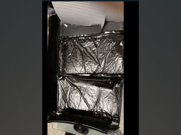 The contraband was packed in two polythene covers and was ingeniously concealed in a specially created false bottom, at the base of the trolley bag. (Photo/ANI)