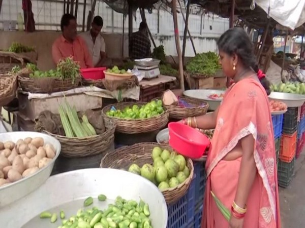 A resident buying vegetables in a market in Hyderabad, Telangana on Thursday. (Photo/ANI)