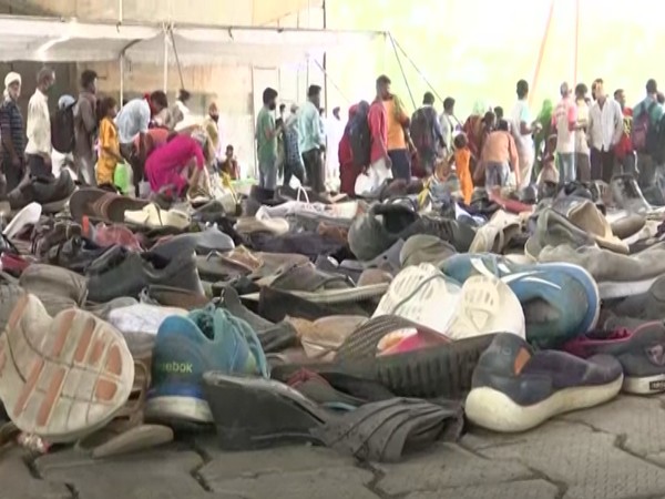 Shoes piled up for needy at the Gandhinagar Bypass road footpath (Photo/ANI)