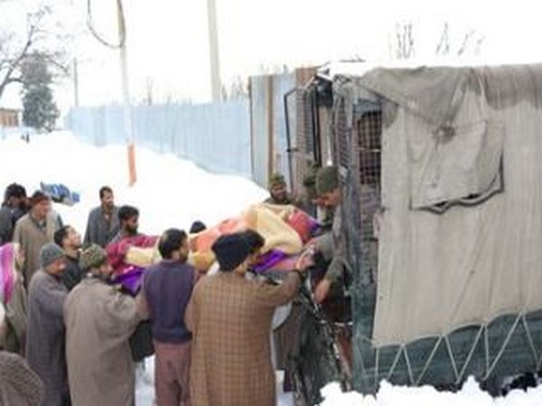 BSF troops carry local woman in labour pain during heavy snowfall in Baramulla (Photo/ANI)