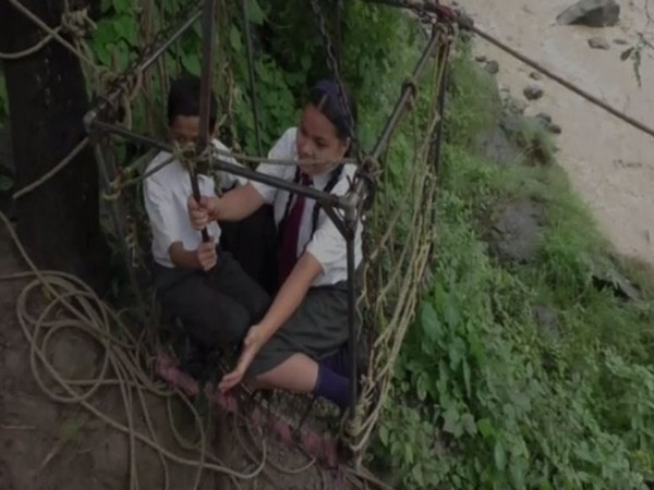 School students risk their lives by travelling in makeshift trolley to cross the river during monsoon in Nainital's Danijela village (Photo/ANI)