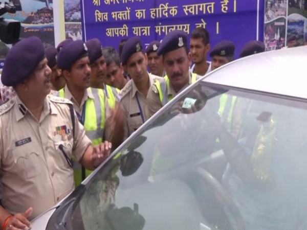 Security personnel pasting RFID chip on a vehicle in Jammu [Photo/ANI]