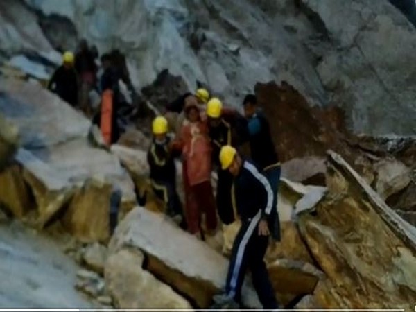 SDRF helping pregnant woman cross blocked Gangotri National Highway (Photo/ANI)