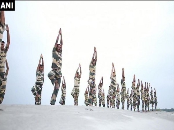 BSF personnel perform yoga asanas on the bank of river Brahmaputra 