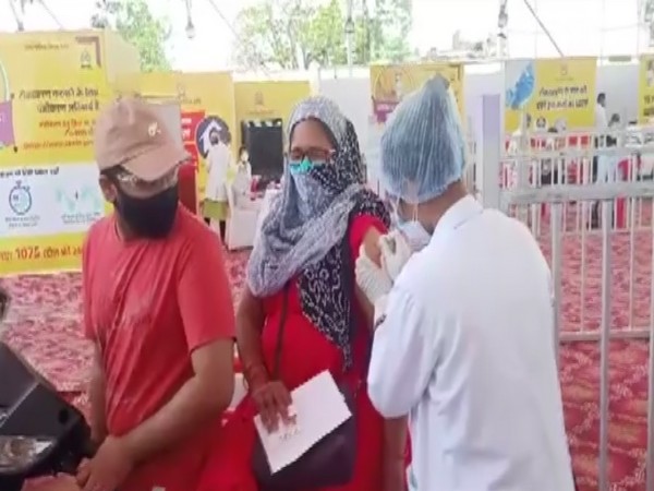 Women getting COVID-19 vaccine shot at a drive-in vaccination centre in Indore. 