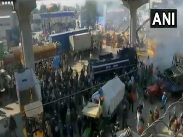 Police use water cannon and tear gas shells to disperse protesting farmers at Tikri border near Delhi-Bahadurgarh highway.