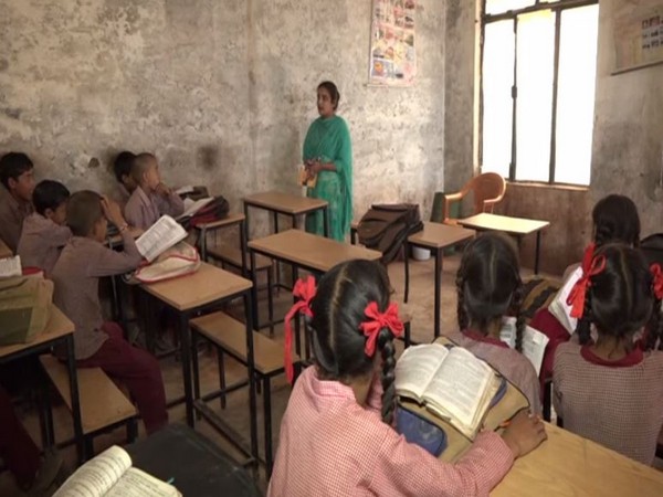 Kavita Devi, daughter of a laborer teaches students coming from financially weaker section in Government Middle School, amid a dire shortage of teaching staff. (Photo/ANI)