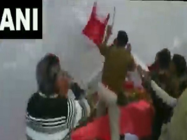 BJP and Congress workers hurling chairs while police try to maintain control in Bhopal on Sunday.