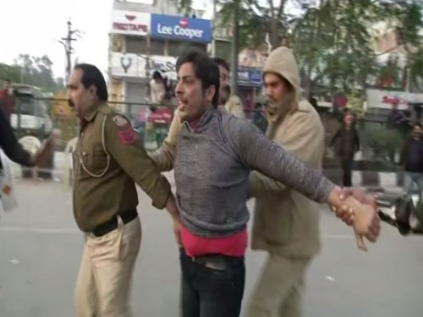 Police taking away the man who open fired in Shaheen Bagh on Saturday (Photo/ANI)