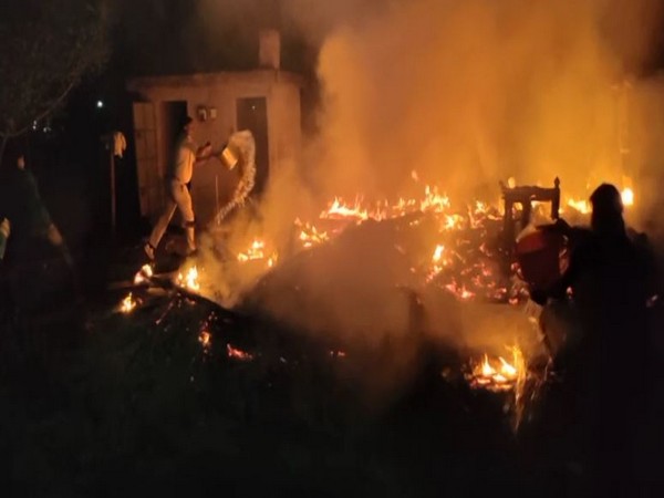 People try to douse fire at a house in North 24 Parganas