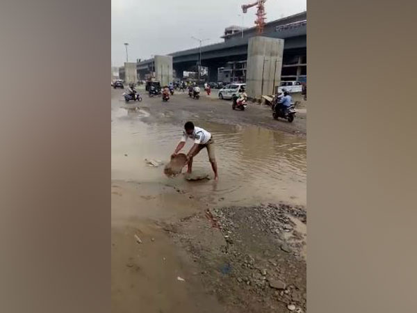 Nagamallu, a traffic inspector diverted water from LG Nagar area to make way for the commuters and vehicles (Photo/ANI)