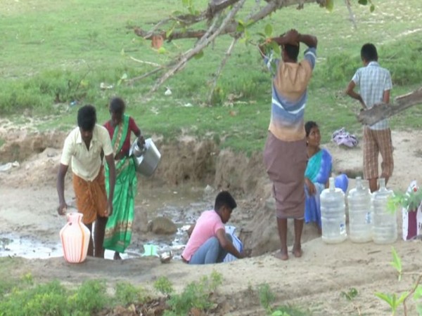 Villagers fetching ground level water 