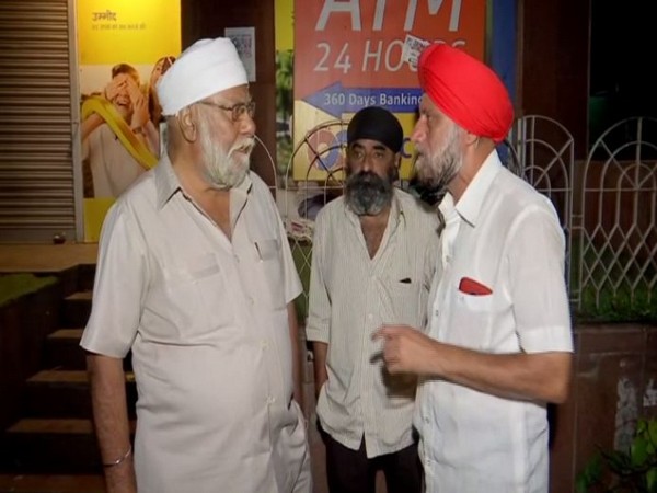 Sikh community people waiting outside the Maharashtra Co-operative (PMC) Bank on Tuesday. Photo/ANI
