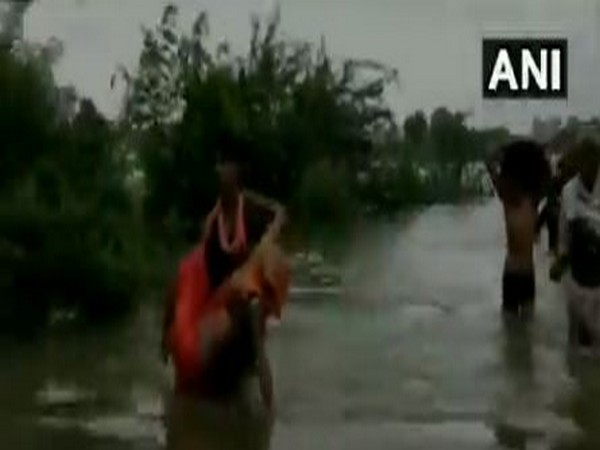 People wade through water in Sheopur, MP