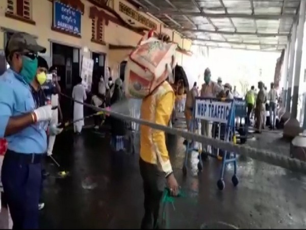 Authorities spray disinfectant at a migrant worker in West Bengal on Tuesday. Photo/ANI