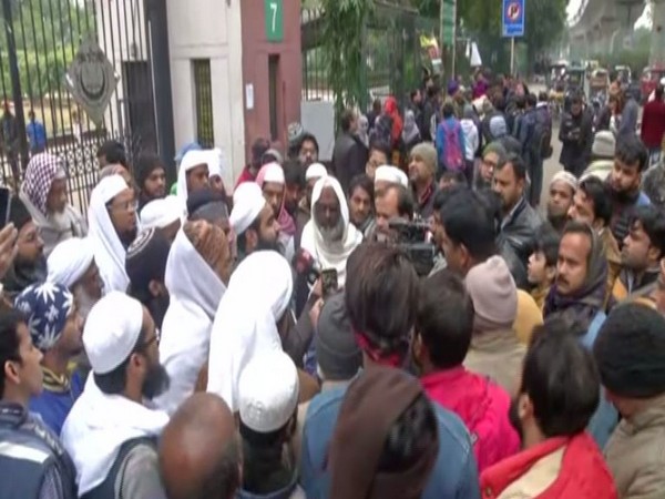 Locals during a protest against CAA outside JMI University on Tuesday.