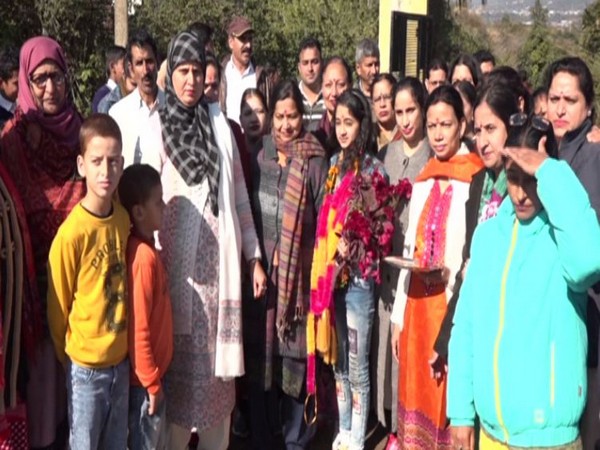 Khushi with her family and teachers in Kawa, J&K, after winning the first prize in Solo Vocal Music Category at the National Level Kala Utsav Competition.