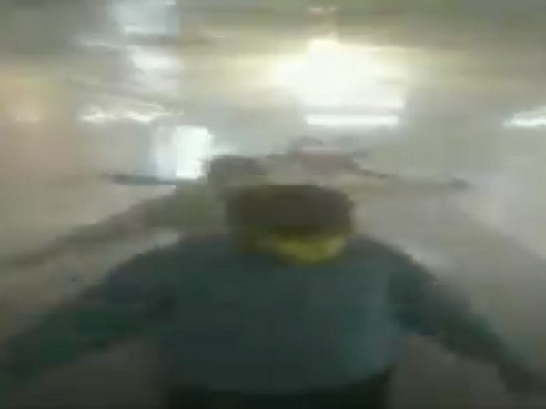 People undergoing fumigation spraying at the fumigation tunnel in Jagadhri Workshop, Haryana. 