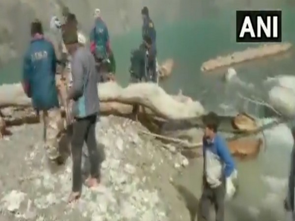 ITBP, along with SDRF, removes trees and boulders from an artificial lake in Chamoli