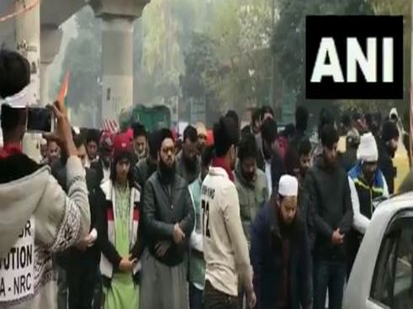 Members of other faiths form a human chain around students and others from Muslim community offering namaz outside Jamia Millia Islamia on Thursday.