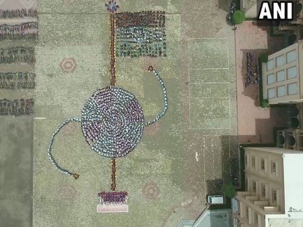 School students unfurled into a National Flag and Rakhi ahead of Independence Day and Raksha Bandha, in Surat, Gujarat. (Photo/ANI)
