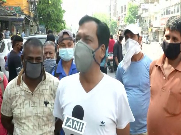 People waiting for liquor stores to open on Wednesday in Delhi. Photo/ANI