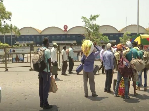 Migrants standing outside Lokmanya Tilak Terminus in Mumbai (Photo/ANI)