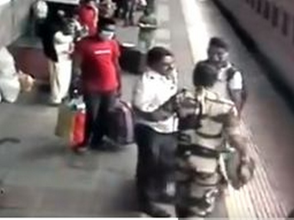 Security forces talking to the rescued man in a screen grab of the CCTV footage of the Indian Railways