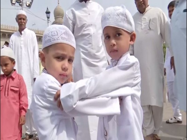 Muslim children greet each other after offering Eid prayer in Hyderabad on Wednesday. [Photo/ANI]