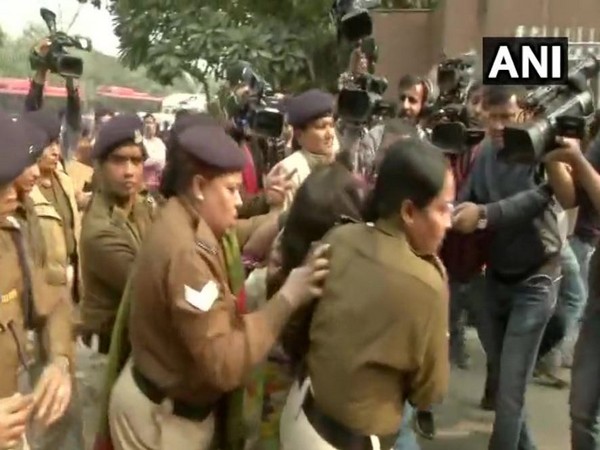 Police personnel take the woman from outside Safdarjung Hospital (Photo/ANI)