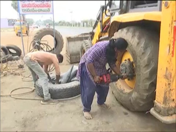 Adilaxmi, Telangana's first woman mechanic working with her husband in their automobile repair. (Photo/ANI)