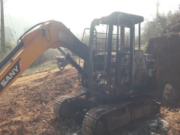 Suspected Maoists set ablaze a JCB used in road construction in Rayagada, Odisha (Photo/ANI)