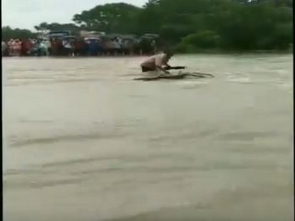 Man washed away while crossing a flooded river in Rajgarh on Thursday. [Photo/ANI]