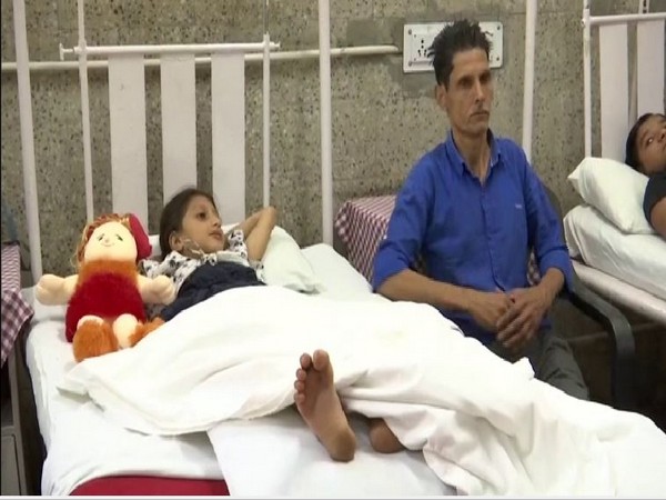 The girl with her father after being treated of snake bite at Army Hospital in Srinagar. Photo/ANI