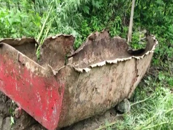 Residents of Nizamula village recover a boat from Durmi lake in Chamoli which was wreacked and 